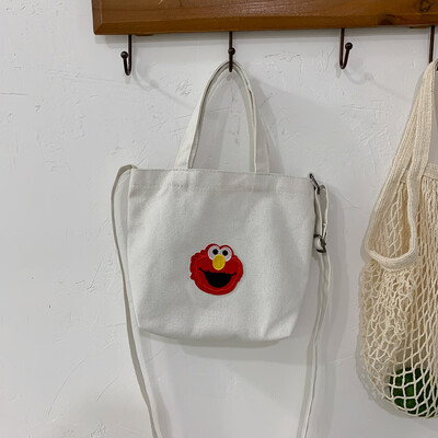 

Casual fashion ugly sesame street portable canvas bag female 2019 new cute cartoon wild shoulder Messenger bag