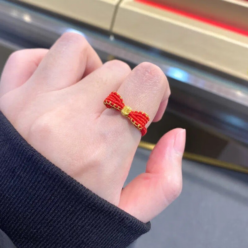 老凤凰迪士尼在逃公主蝴蝶结戒指女999足金猫眼珠转运珠编织黑绳食指