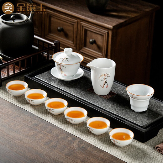 Gold inlaid jade ceramic kung fu tea set complete set of covered bowl teacup white porcelain household simple gift box high-end festival covered bowl set