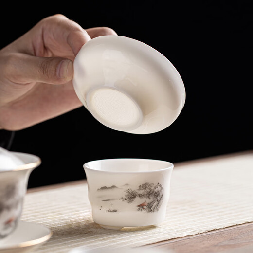 Gold inlaid jade Kung Fu tea set, complete set of home mutton fat jade porcelain drinking tea, tea gift box, high-end ink mountains and seas