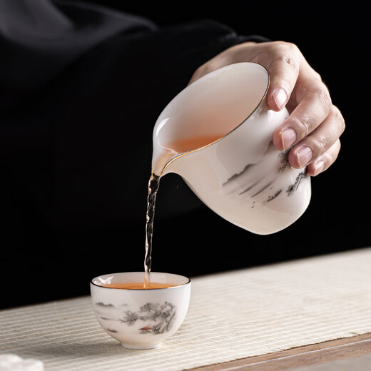 Gold inlaid jade Kung Fu tea set, complete set of home mutton fat jade porcelain drinking tea, tea gift box, high-end ink mountains and seas