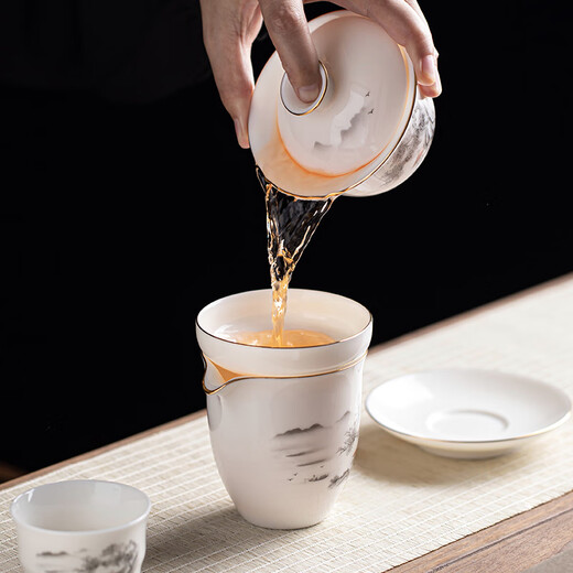 Gold inlaid jade Kung Fu tea set, complete set of home mutton fat jade porcelain drinking tea, tea gift box, high-end ink mountains and seas