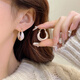 Pendientes de esmalte de goteo para mujeres Light Luxury Nicho Diseño Sense Pendientes de auriculares de alta gama 2025 Pendientes de temperamento nuevo de moda Pendientes de glaseado de goteo blanco E3271