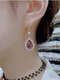 Xiandie Super Flash Purple Crystal Water Drop Boucles pour les femmes 2024 Nouvelles et haut de gamme de papillons d'oreille et de boucles d'oreilles de luxe