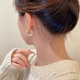 Pendientes de esmalte de goteo para mujeres Light Luxury Nicho Diseño Sense Pendientes de auriculares de alta gama 2025 Pendientes de temperamento nuevo de moda Pendientes de glaseado de goteo blanco E3271