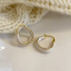 Pendientes de esmalte de goteo para mujeres Light Luxury Nicho Diseño Sense Pendientes de auriculares de alta gama 2025 Pendientes de temperamento nuevo de moda Pendientes de glaseado de goteo blanco E3271