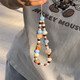 Beiyipin mobile phone lanyard wrist new checkered bear ceramic puppy beaded mobile phone chain lanyard Maillard color acrylic cute mobile phone chain for women