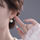 Qi Xiaomi camellia earrings for women 2025 new niche high-end imitation pearl earrings light luxury earrings temperament tassel earrings a pair of camellia earrings